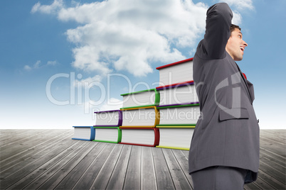 Composite image of thinking businessman scratching head