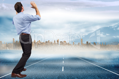 Composite image of businessman posing with arms up