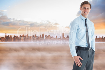 Composite image of smiling businessman standing with hand in poc