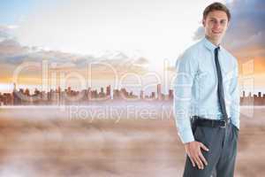 Composite image of smiling businessman standing with hand in poc