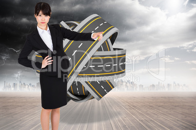 Composite image of businesswoman pointing