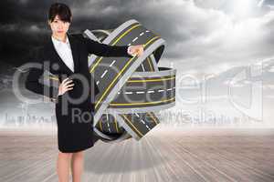 Composite image of businesswoman pointing