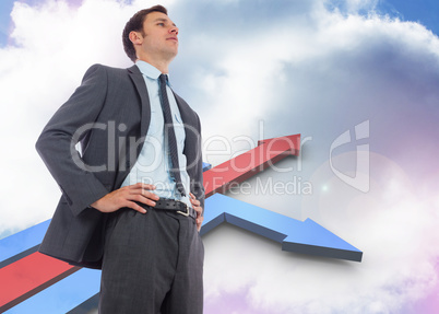 Composite image of stern businessman with hands on hips