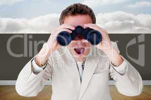 Composite image of positive businessman using binoculars