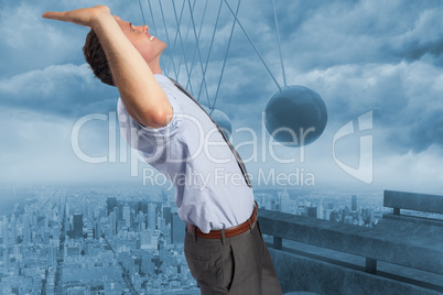 Composite image of businessman standing with hands up