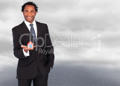 Composite image of businessman with house for real estate concep