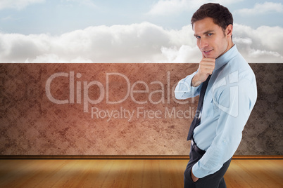 Composite image of thoughtful businessman with hand on chin