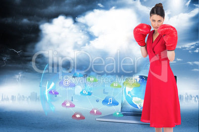 Composite image of elegant brunette in red dress wearing boxing