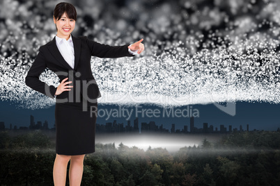 Composite image of smiling businesswoman pointing