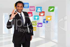 Composite image of businessman showing okay sign