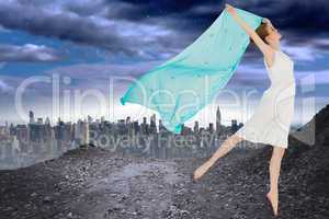 Composite image of young beautiful female dancer with blue scarf