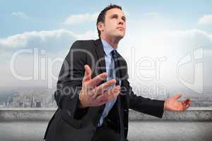 Composite image of businessman posing with arms out