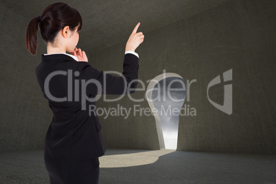 Composite image of thoughtful businesswoman pointing