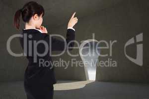 Composite image of thoughtful businesswoman pointing