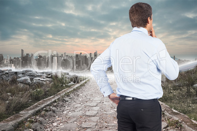 Composite image of thinking businessman touching his chin