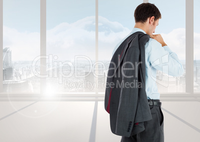 Composite image of businessman holding his jacket