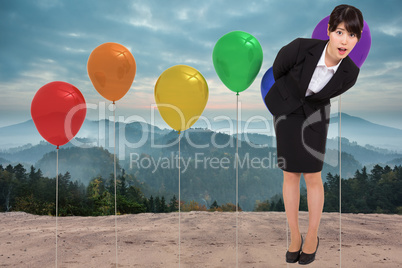 Composite image of surpised businesswoman bending
