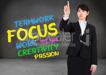 Composite image of focused businesswoman pointing