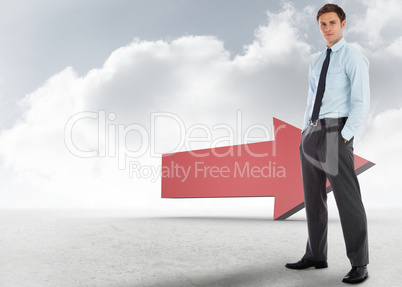 Composite image of serious businessman standing with hands in po