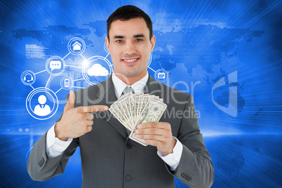 Composite image of businessman pointing at bank notes in his han