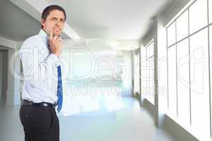 Composite image of thinking businessman touching his chin