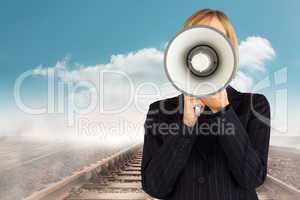 Composite image of closeup of a businesswoman with a megaphone h