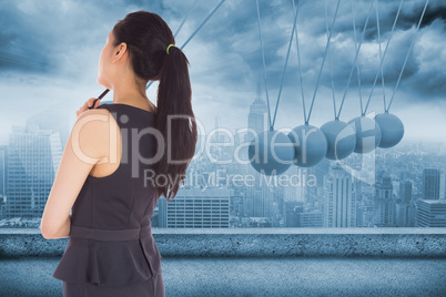 Composite image of thoughtful asian businesswoman