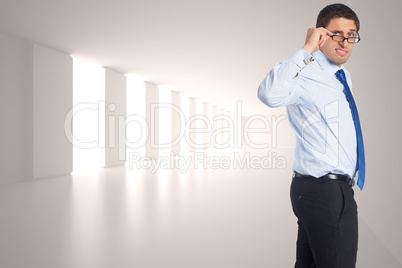 Composite image of thinking businessman tilting glasses