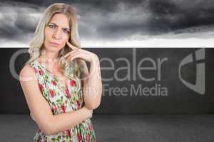 Composite image of frowning pretty blonde wearing flowered dress