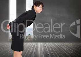 Composite image of serious businesswoman bending