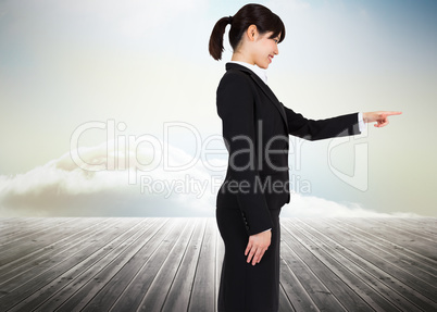 Composite image of smiling businesswoman pointing