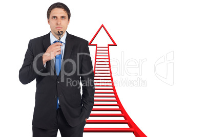 Composite image of thinking businessman holding glasses Composite image of thinking businessman holding glasses