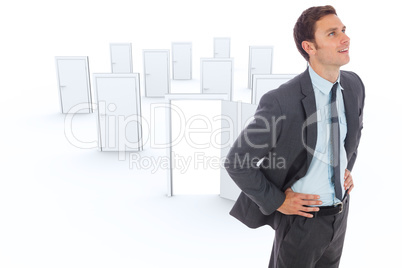 Composite image of cheerful businessman standing with hands on h