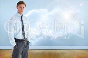 Composite image of serious businessman standing with hands in po