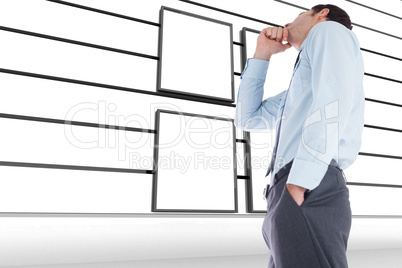 Composite image of thoughtful businessman with hand on chin