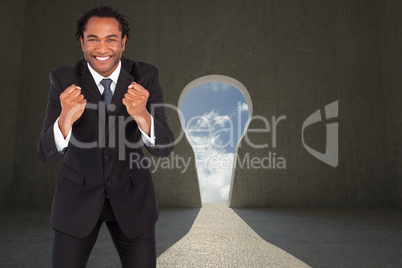 Composite image of successful businessman with raised arms