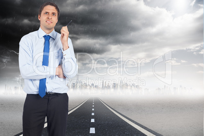 Composite image of thinking businessman holding pen