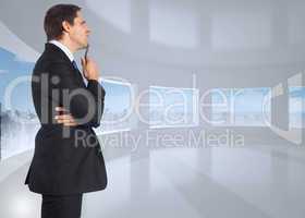 Composite image of thinking businessman holding pen