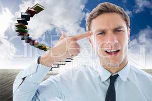 Composite image of businessman making gun gesture