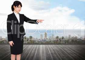 Composite image of focused businesswoman pointing