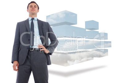 Composite image of stern businessman with hand on hip