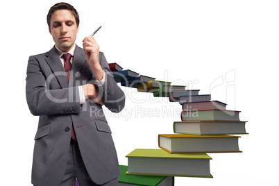 Composite image of thoughtful businessman holding pen