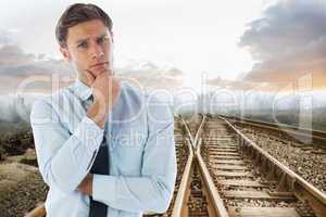 Composite image of thinking businessman with hand on chin