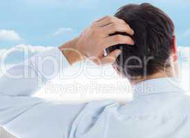 Composite image of businessman scratching his head