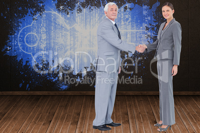 Composite image of businessman and woman shaking hands