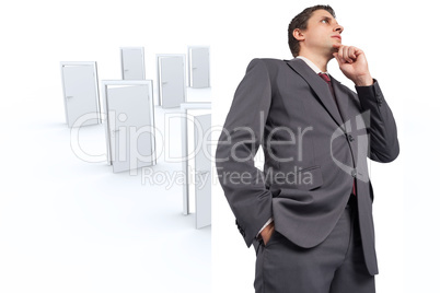 Composite image of thoughtful businessman with hand on chin