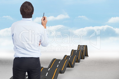 Composite image of thinking businessman holding pen