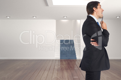 Composite image of thinking businessman holding pen