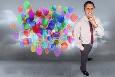 Composite image of thinking businessman touching his chin