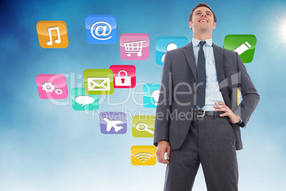 Composite image of cheerful businessman with hand on hip